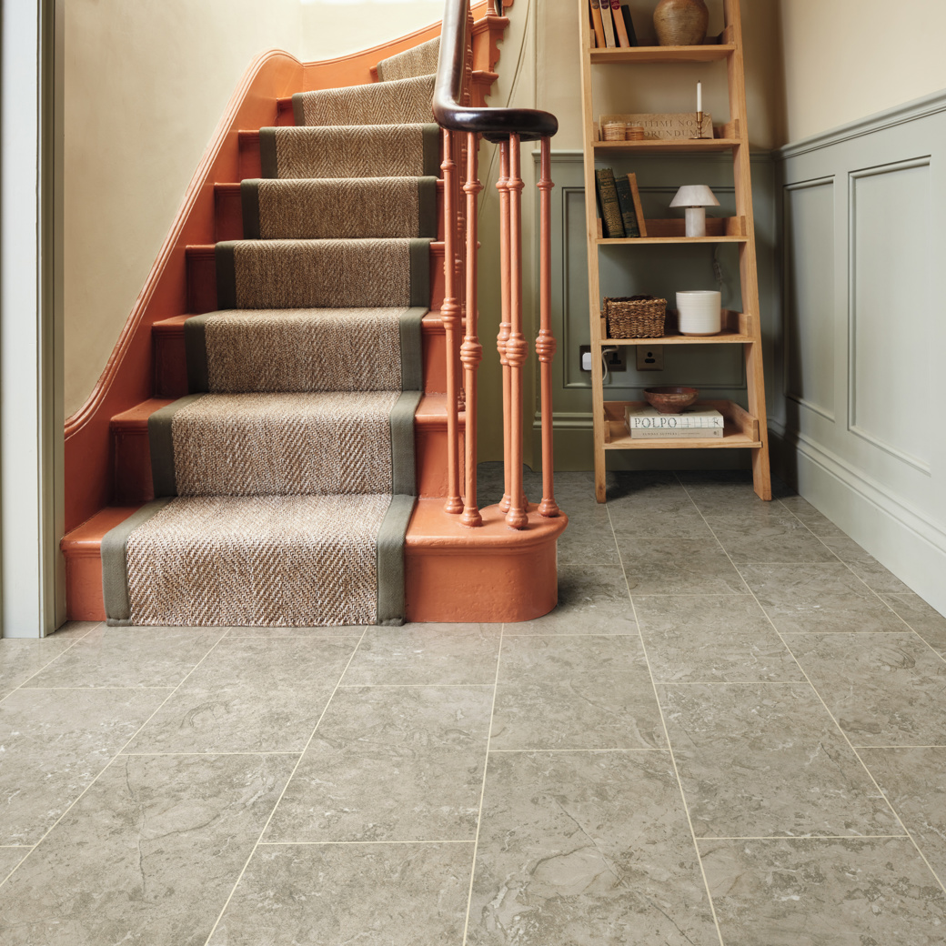 Lunar Limestone stone effect LVT flooring laid in a hallway with a design strip